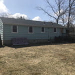 before picture showing old wood clapboard siding.