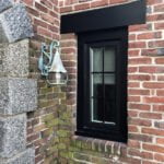 Beautiful new black casement window installed in brick.