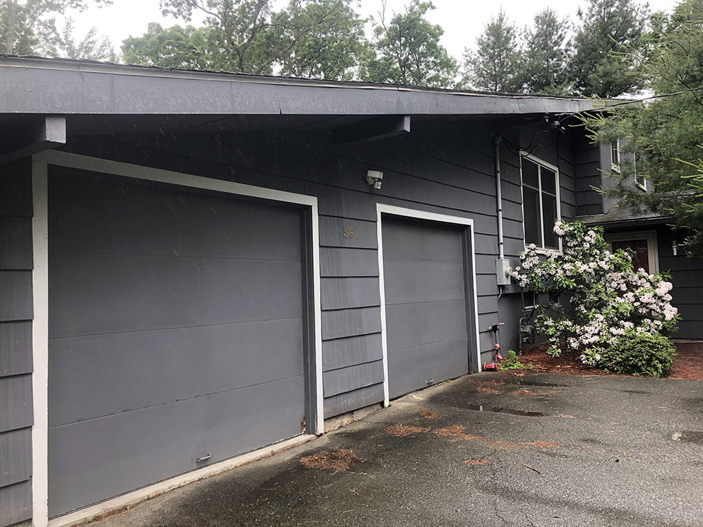 elongated pitched roofing system with deep soffit overhangs