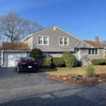 After Photo showing Entry Door, Garage Door, and vinyl siding installed