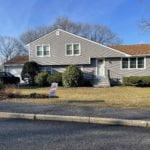 After photo showing new entry door and vinyl siding