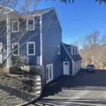 After Photo showing right elevation of home with new certainteed midnight blue vinyl siding