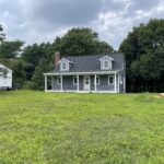 after photo of new roofing, siding, and farmers porch