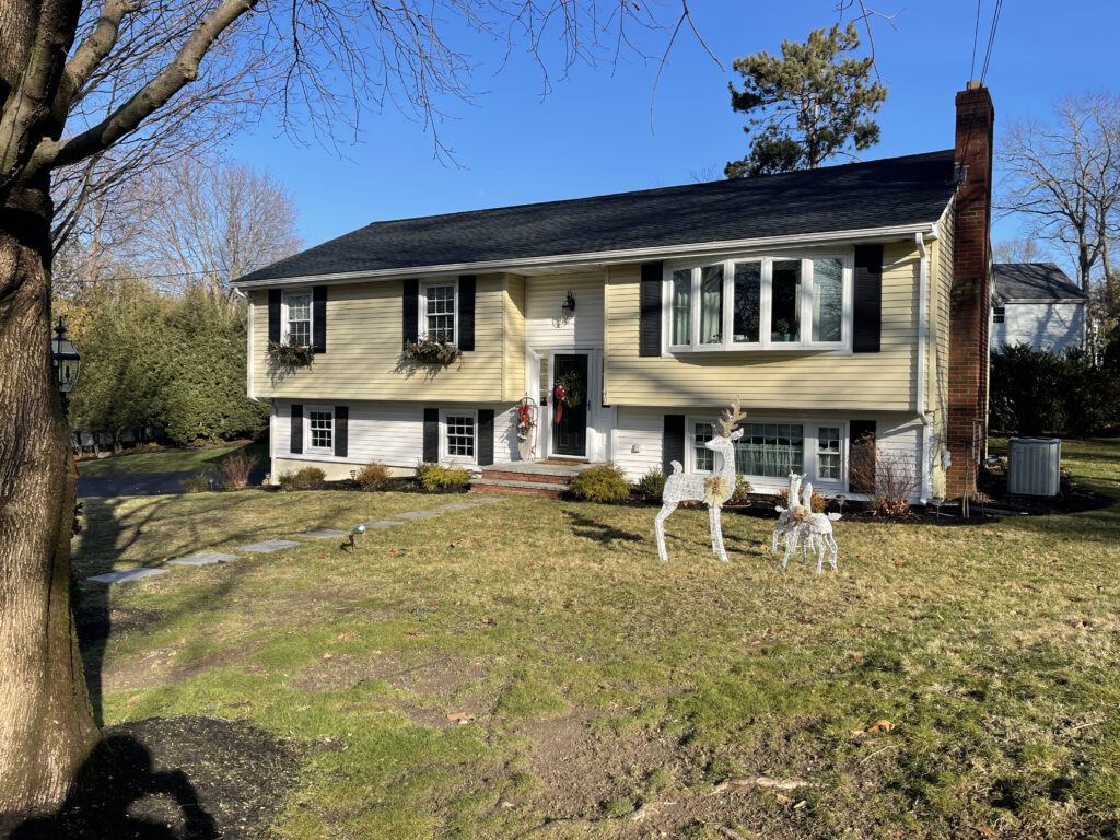 Before the home renovation installation of new roofing, siding, windows, and entry door.