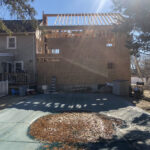 back elevation of house addition in stoughton, massachusetts almost fully framed.