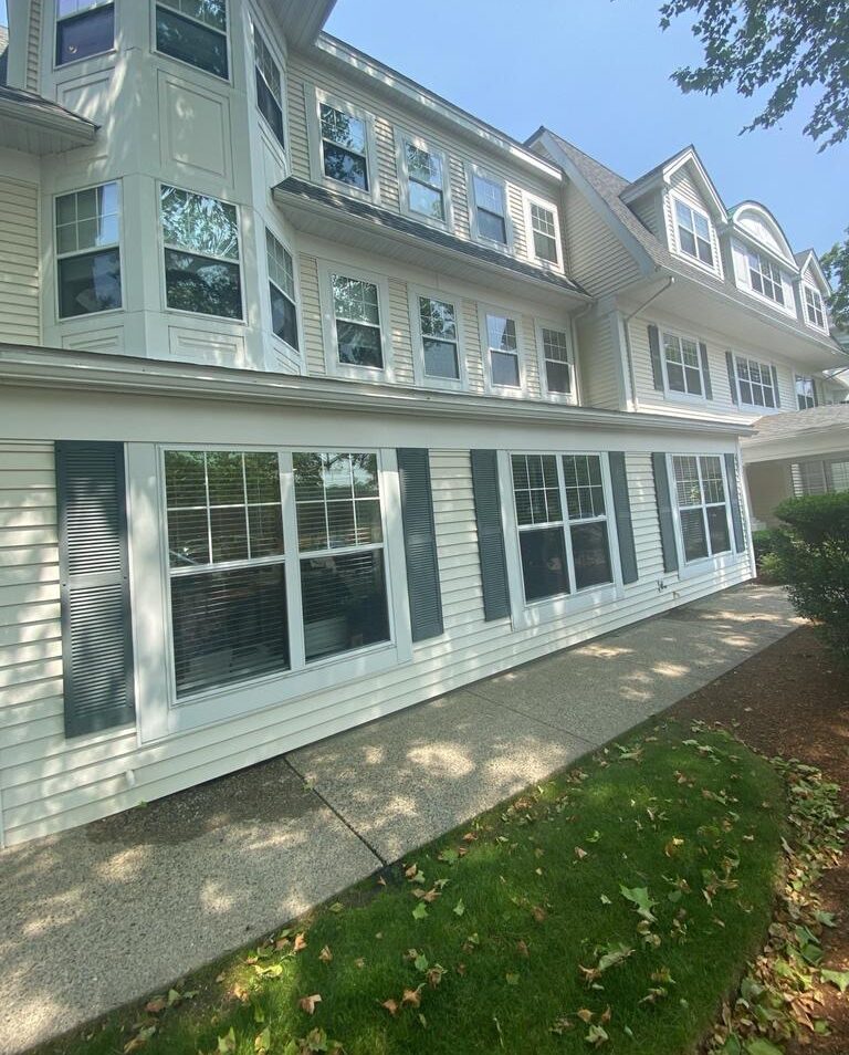 Charter Senior Living Dedham MA facility exterior view showing ongoing upgrades including siding, fascia, and trim