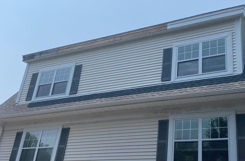 Charter Senior Living Dedham MA exterior before facility upgrades showing aged fascia and trim