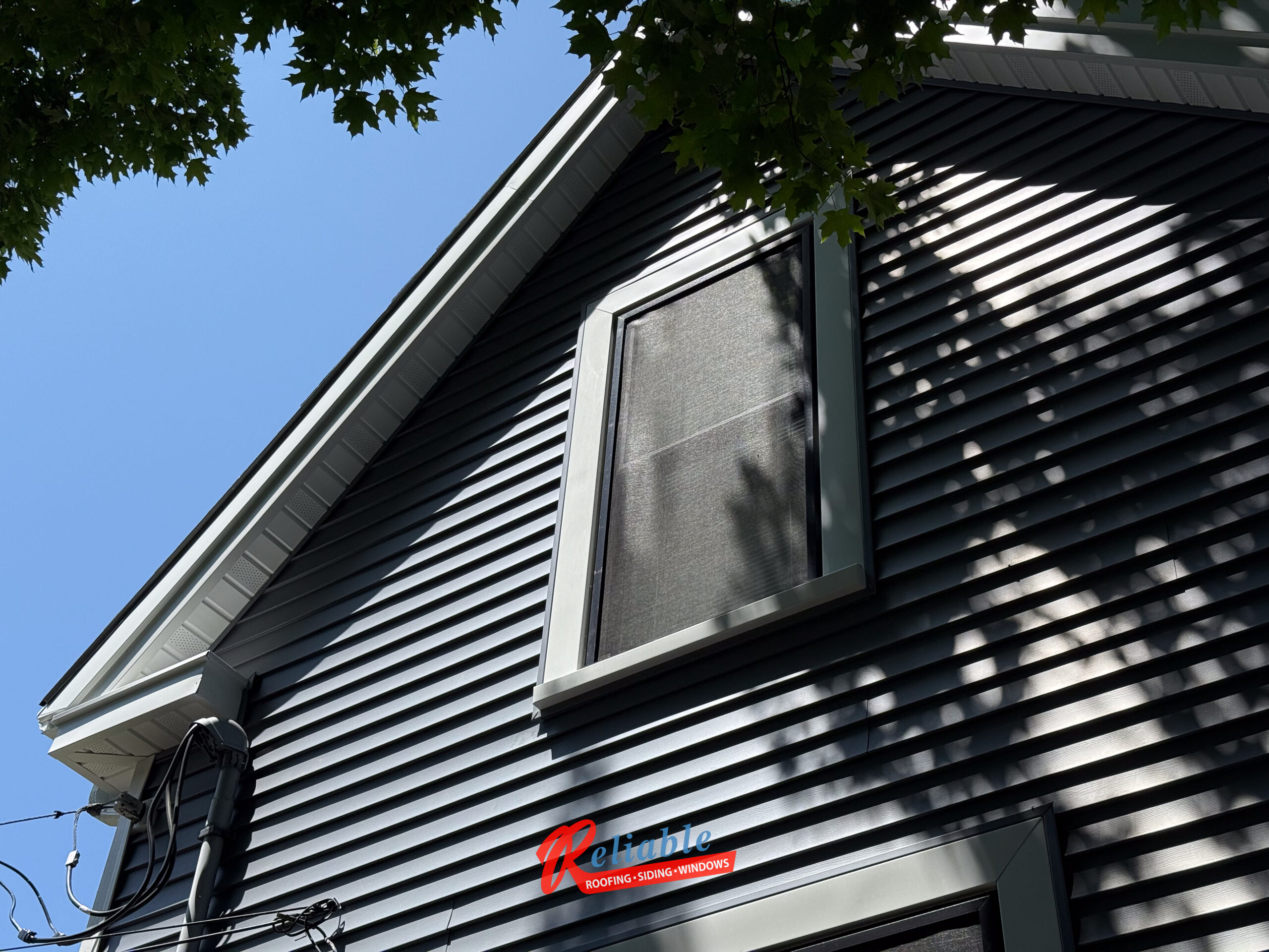 Before exterior renovation in Easton MA with outdated siding and windows