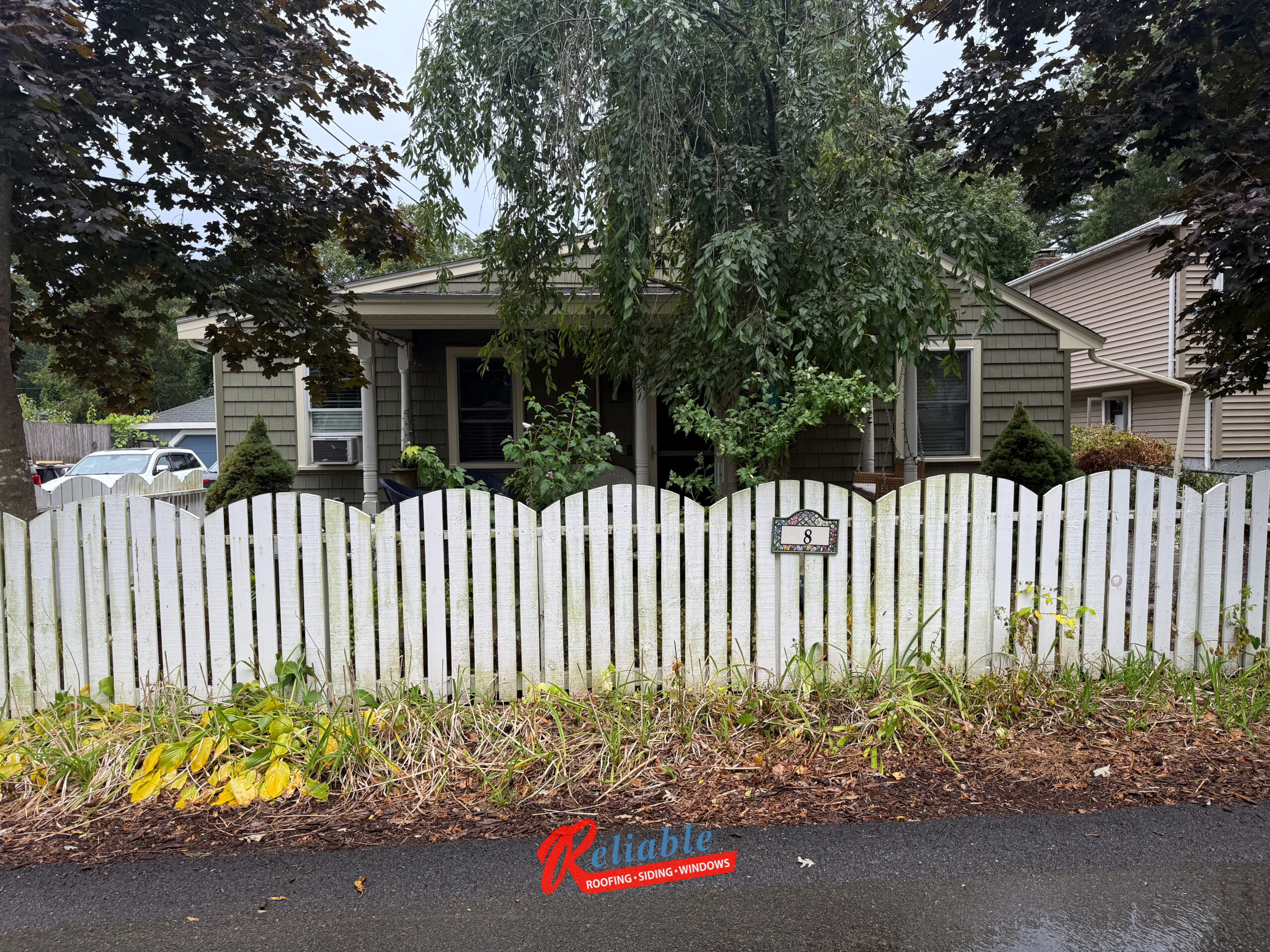Harvey Classic white vinyl patio door with blinds between the glass installed in Randolph MA exterior renovation, providing natural light, privacy, and low maintenance
