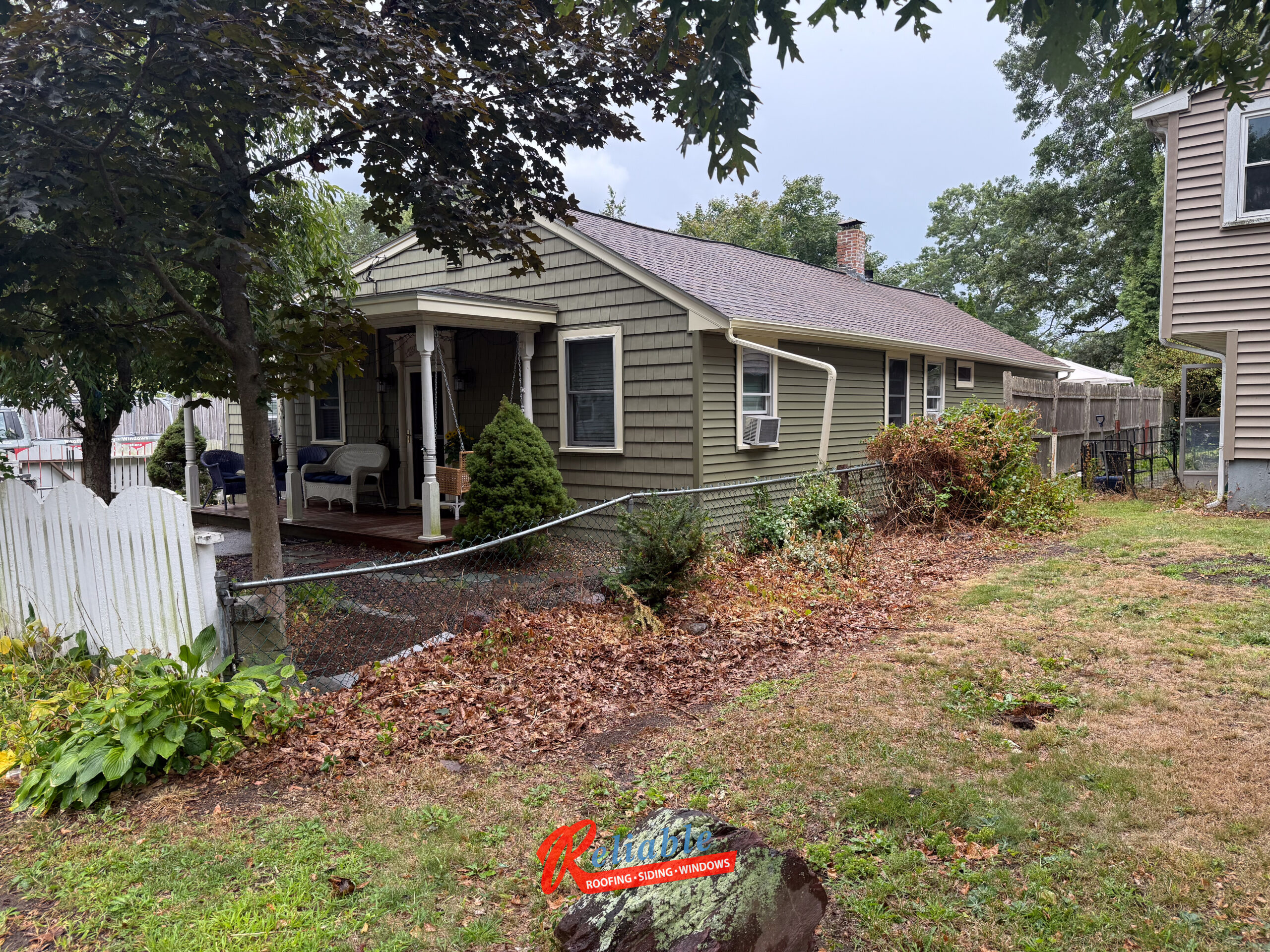 Harvey Classic white vinyl patio door with blinds between the glass installed in Randolph MA exterior renovation, providing natural light, privacy, and low maintenance